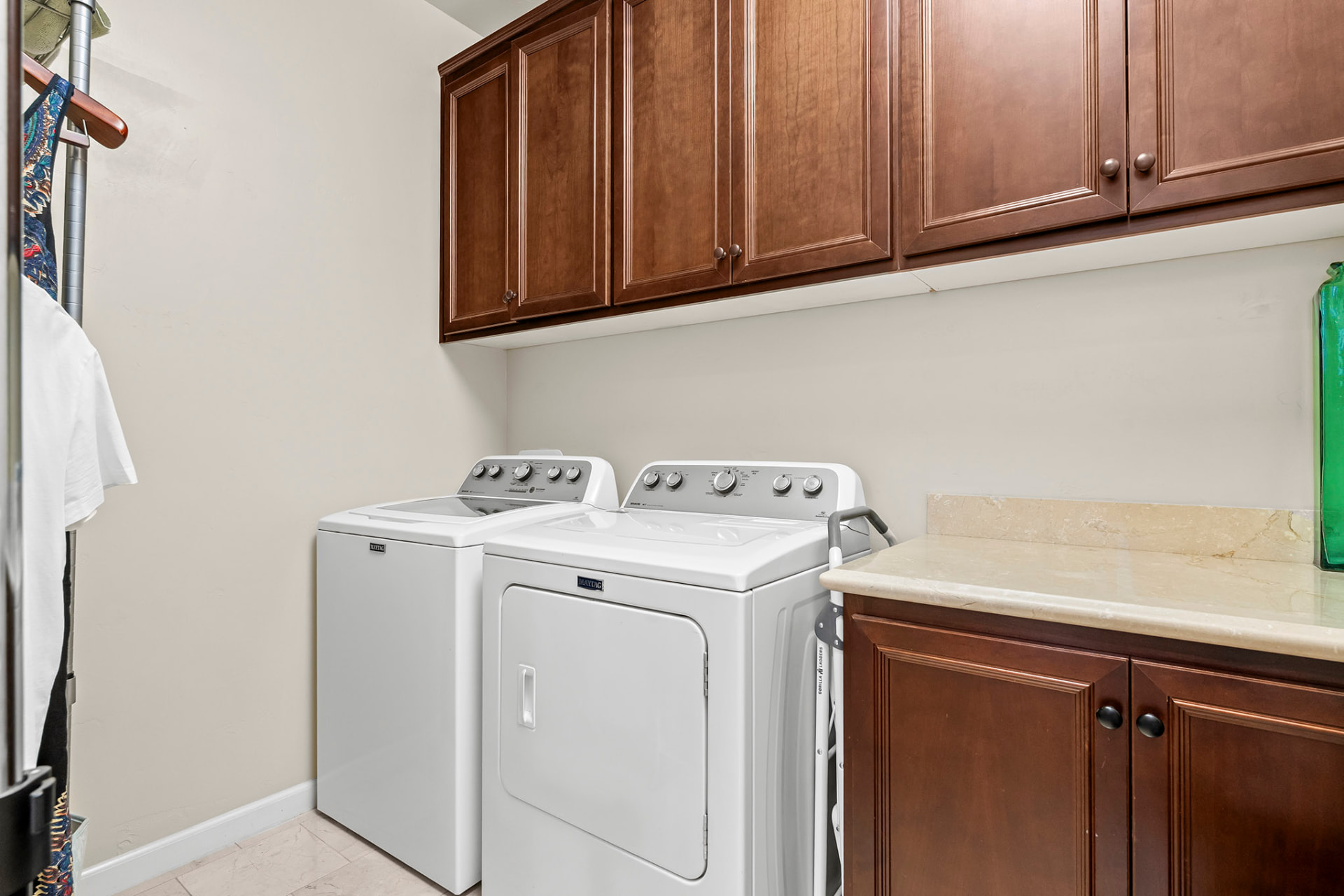 Dedicated laundry room with cherry cabinetry and a folding counter
