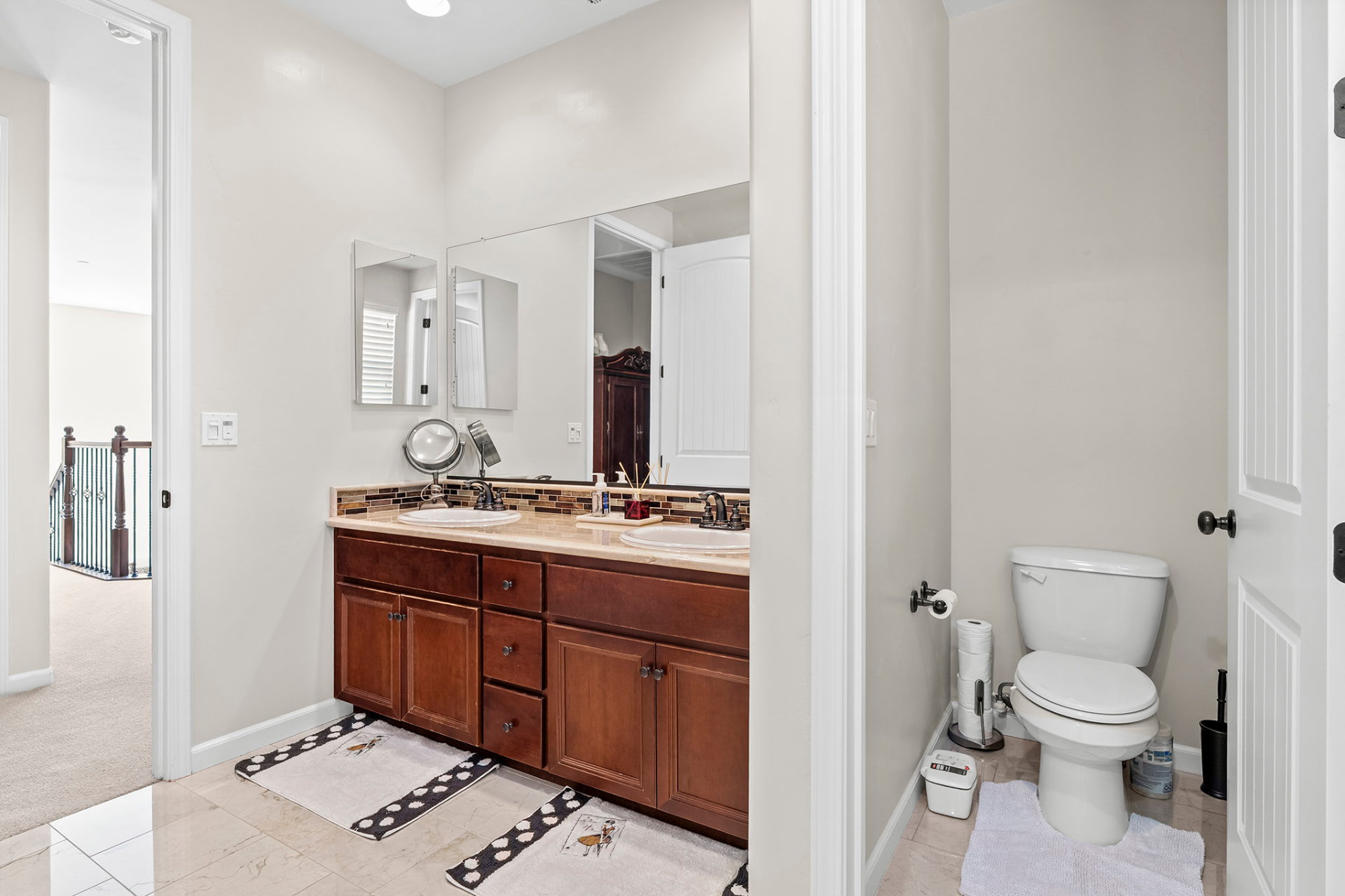 Full bath opening to the upstairs hallway with a separate water closet